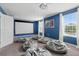 Bright game room with a projector screen, bean bag chairs, and natural light, designed for fun at 1520 Mulligan Blvd, Davenport, FL 33896