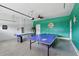 Spacious game room equipped with a ping pong table and an air hockey table at 1520 Mulligan Blvd, Davenport, FL 33896