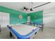 Finished garage game room featuring an air hockey table at 1520 Mulligan Blvd, Davenport, FL 33896