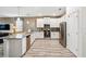 Spacious kitchen featuring white cabinets, granite countertops and stainless steel appliances at 1520 Mulligan Blvd, Davenport, FL 33896