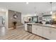 Open-concept kitchen with stainless steel appliances and view of living and dining areas at 1520 Mulligan Blvd, Davenport, FL 33896