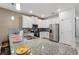 Kitchen featuring granite countertops, stainless steel appliances, and white cabinetry at 1520 Mulligan Blvd, Davenport, FL 33896