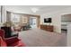 Spacious bonus room featuring neutral paint, carpeted floors, stylish furniture, and a large screen TV at 1520 Mulligan Blvd, Davenport, FL 33896