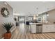 Open-concept living area with tile floors connecting kitchen, dining, and living spaces at 1520 Mulligan Blvd, Davenport, FL 33896