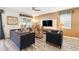 Cozy living room featuring large windows and comfortable seating arrangement at 1520 Mulligan Blvd, Davenport, FL 33896