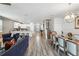 Open-concept living space with dining area, kitchen, and staircase to the upper level at 1520 Mulligan Blvd, Davenport, FL 33896