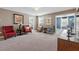 This bonus room features neutral paint, carpeted floors, stylish furniture, and a television at 1520 Mulligan Blvd, Davenport, FL 33896
