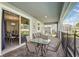 Outdoor patio dining area with seating for six and view to backyard pool at 1520 Mulligan Blvd, Davenport, FL 33896