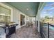 Inviting covered patio with outdoor grill and a beautiful view of the pool at 1520 Mulligan Blvd, Davenport, FL 33896