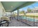 Enjoyable covered patio with a built-in grill and outdoor seating by the pool at 1520 Mulligan Blvd, Davenport, FL 33896