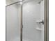 Modern shower features sleek glass doors, white tiles, and convenient built-in shelving for toiletries at 1520 Mulligan Blvd, Davenport, FL 33896