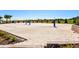 Sand volleyball court with nets and lush landscaping, providing a recreational amenity for residents and guests at 1520 Mulligan Blvd, Davenport, FL 33896