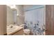 Practical bathroom featuring a floral shower curtain and neutral vanity at 1525 Jaguar Cir, Apopka, FL 32712