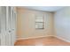 Cozy bedroom featuring a window, closet, and sleek laminate floors at 1525 Jaguar Cir, Apopka, FL 32712