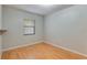 Neutral bedroom with a window providing natural light and classic wood-look floors at 1525 Jaguar Cir, Apopka, FL 32712