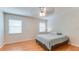 Well-lit bedroom with a ceiling fan, two windows, and laminate flooring at 1525 Jaguar Cir, Apopka, FL 32712