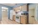 Bright kitchen with white appliances and light wood cabinets, leading to other rooms in the house at 1525 Jaguar Cir, Apopka, FL 32712