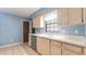 Kitchen with white countertops, wood cabinets, stainless steel dishwasher, and a window at 1525 Jaguar Cir, Apopka, FL 32712