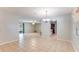 Open-concept living room with tile flooring and neutral walls leading to the kitchen and dining area at 1525 Jaguar Cir, Apopka, FL 32712