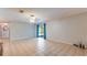 Open-concept living room with tile flooring and blue curtains, adjacent to other rooms in the house at 1525 Jaguar Cir, Apopka, FL 32712