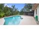 Inviting in-ground pool with a spacious patio and screened enclosure at 1525 Jaguar Cir, Apopka, FL 32712
