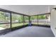 Enclosed patio with a blue chair providing an enjoyable view of the backyard at 1525 Jaguar Cir, Apopka, FL 32712