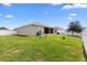 Spacious backyard with lawn, fence, and screened porch perfect for outdoor entertaining at 15356 White Tail Loop, Mascotte, FL 34753