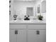 Bathroom featuring a double sink vanity with a large mirror, clean lines, and decorative accents at 15356 White Tail Loop, Mascotte, FL 34753