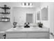 A bathroom showcasing double sinks, bright lighting, and modern fixtures, offering functionality and style at 15356 White Tail Loop, Mascotte, FL 34753