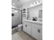 Modern bathroom with dual sinks, sleek black hardware, and a glass shower at 15356 White Tail Loop, Mascotte, FL 34753