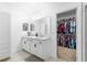 Bright bathroom features double vanity, walk-in closet, and neutral tiling at 15356 White Tail Loop, Mascotte, FL 34753