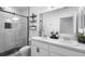 Modern bathroom boasts a double vanity, glass shower, and black accents at 15356 White Tail Loop, Mascotte, FL 34753