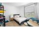 Bedroom with a cozy bed, large window, and unique plush seating, offering a comfortable and inviting atmosphere at 15356 White Tail Loop, Mascotte, FL 34753