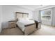 Bedroom featuring a wooden bed frame, plush bedding, and bedside tables creating a cozy and inviting space at 15356 White Tail Loop, Mascotte, FL 34753