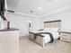 Spacious bedroom featuring a comfortable bed, en-suite bathroom entrance, and ample natural light at 15356 White Tail Loop, Mascotte, FL 34753