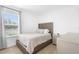 Cozy bedroom featuring a comfortable bed, natural light, and neutral carpeting at 15356 White Tail Loop, Mascotte, FL 34753