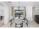 Lovely breakfast nook with modern lighting, round table and seating plus view of outdoor weight-lifting area at 15356 White Tail Loop, Mascotte, FL 34753