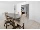 Bright dining room features an elegant table with seating for four and tile flooring at 15356 White Tail Loop, Mascotte, FL 34753