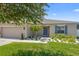Inviting home with a well-manicured lawn, a lovely front garden, and a welcoming entrance at 15356 White Tail Loop, Mascotte, FL 34753