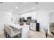 Stylish kitchen featuring white cabinets, stainless steel appliances, and an island with barstool seating at 15356 White Tail Loop, Mascotte, FL 34753