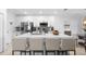 Modern kitchen with a large center island, sleek countertops, and stainless steel appliances at 15356 White Tail Loop, Mascotte, FL 34753