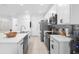 Contemporary kitchen featuring white cabinets, a center island, and modern appliances for cooking convenience at 15356 White Tail Loop, Mascotte, FL 34753