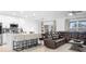 Open concept living space featuring kitchen with breakfast bar and comfortable leather sectional seating at 15356 White Tail Loop, Mascotte, FL 34753