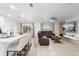 Bright open-concept living space boasts tile floors, breakfast bar seating, and a comfortable leather sectional at 15356 White Tail Loop, Mascotte, FL 34753