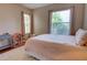 Comfortable bedroom featuring two windows, a dollhouse, and a comfortable bed on a decorative rug at 1676 Bear Crossing Cir, Apopka, FL 32703