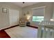 Cozy bedroom featuring a large window, comfortable chair, and a stylish area rug at 1676 Bear Crossing Cir, Apopka, FL 32703