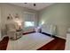 Serene Bedroom featuring a crib, rocking chair, and soft decor, perfect for a peaceful environment at 1676 Bear Crossing Cir, Apopka, FL 32703