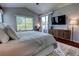 Bright bedroom with a desk by the window, decorative rug, TV, and wooden dresser for ample storage space at 1676 Bear Crossing Cir, Apopka, FL 32703