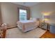 Cozy bedroom with pink accents, featuring a comfortable bed, a nightstand, and a plush rug on hardwood floors at 1676 Bear Crossing Cir, Apopka, FL 32703