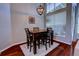 Cozy dining area with a wooden table set, chandelier, and natural light creates an inviting space for meals at 1676 Bear Crossing Cir, Apopka, FL 32703